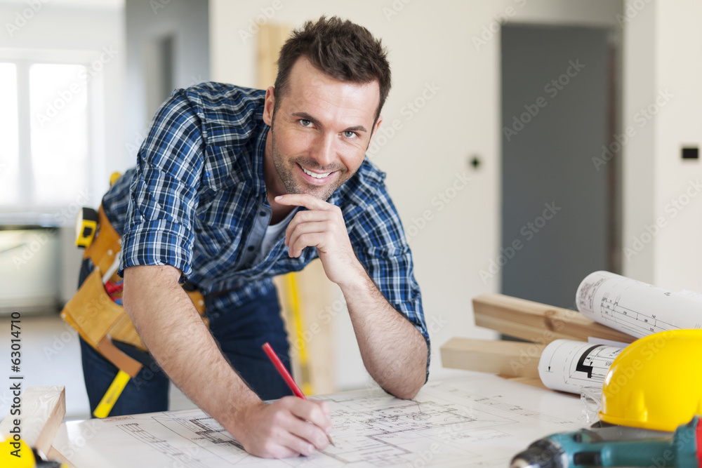 Portrait of construction worker with plans Portrait of construction worker with plans