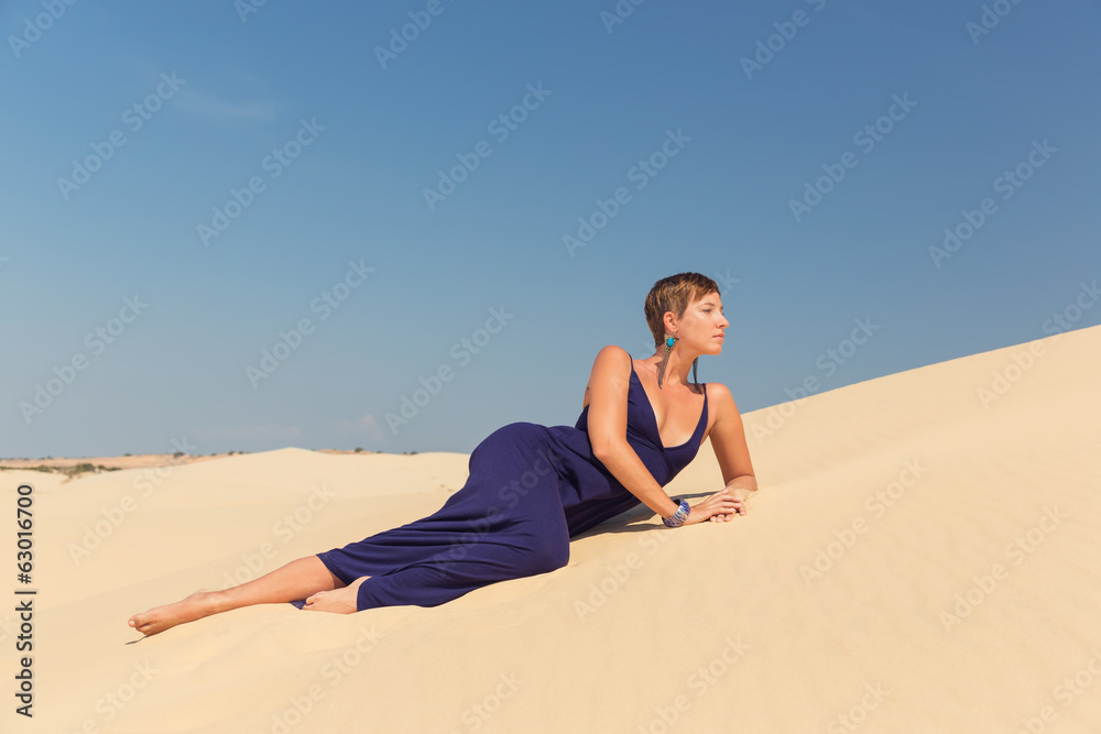 Beautiful woman in a dress on a beach in the dunes Beautiful woman in a dress on a beach in the dunes