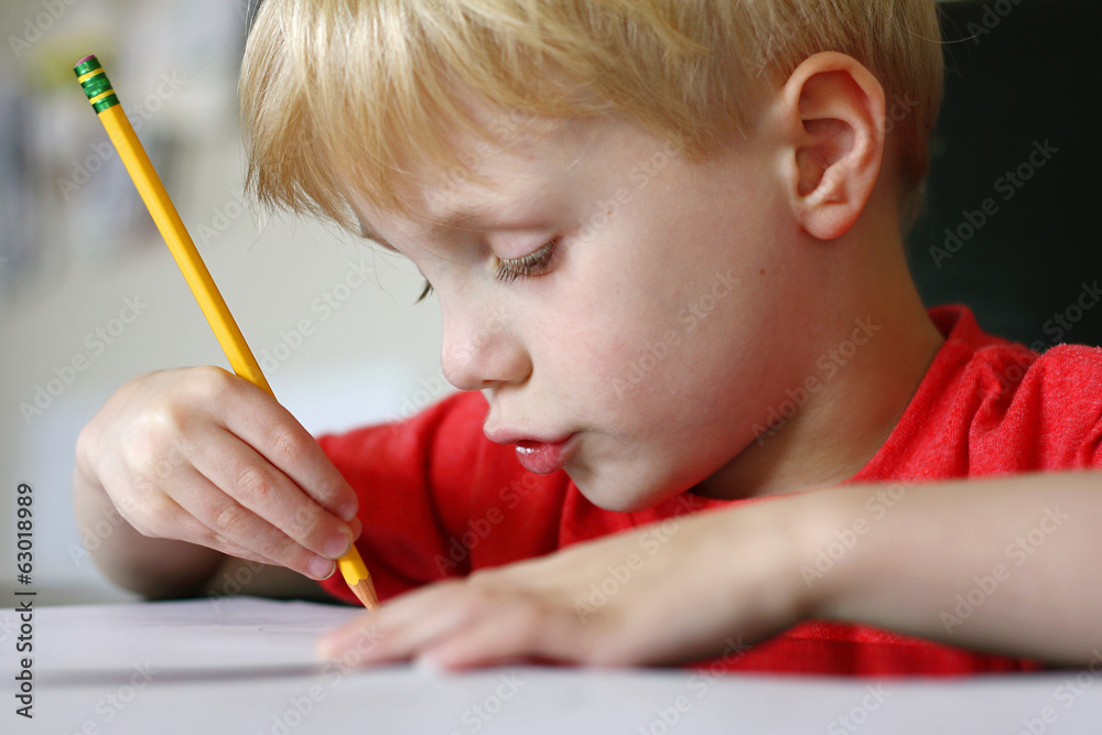 Young Child Drawing with Paper and Pencil Young Child Drawing with Paper and Pencil