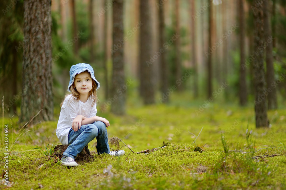 Adorable little girl hiking in the forest Adorable little girl hiking in the forest