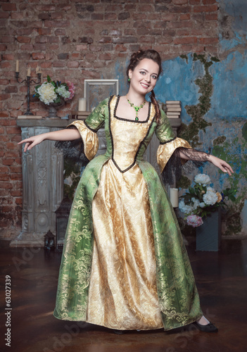 Smiling beautiful woman in medieval dress dance