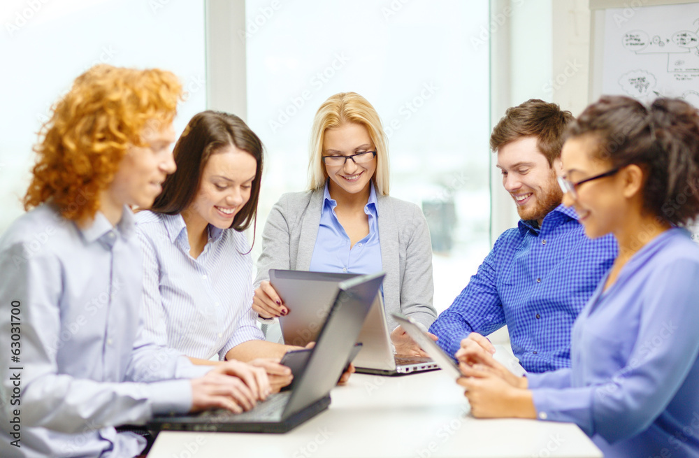 smiling team with laptop and table pc computers smiling team with laptop and table pc computers