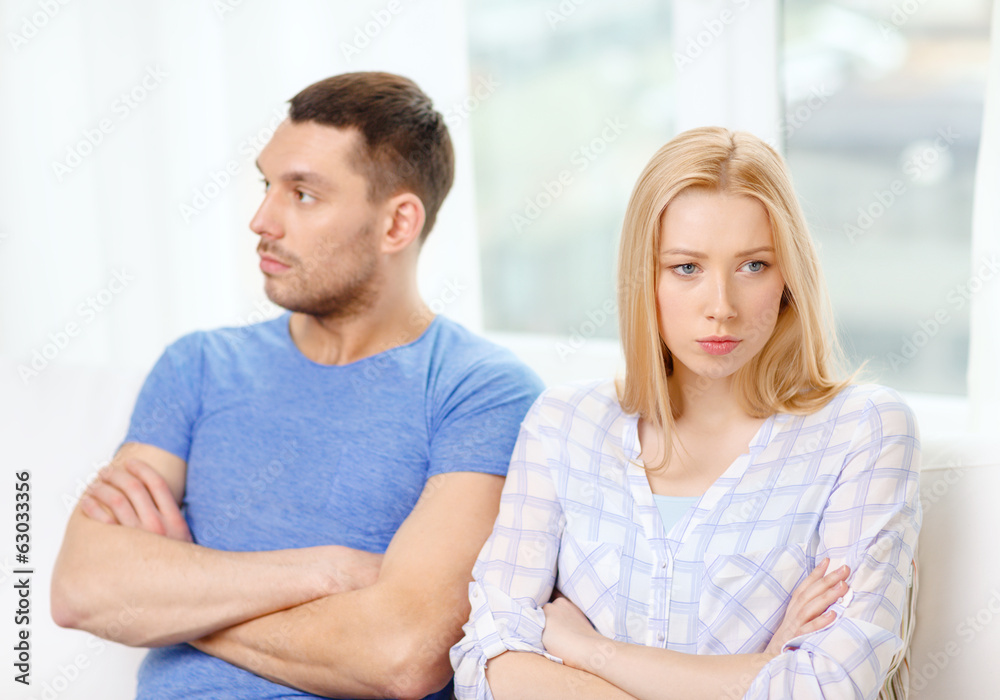 unhappy couple having argument at home