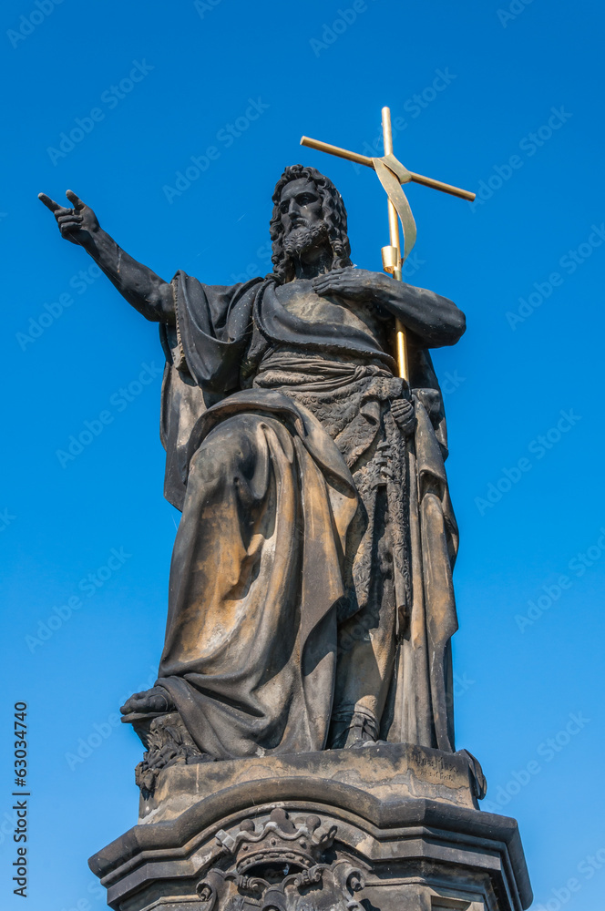 Statue of Jesus on Charles Bridge in Prague, Czech Republic.