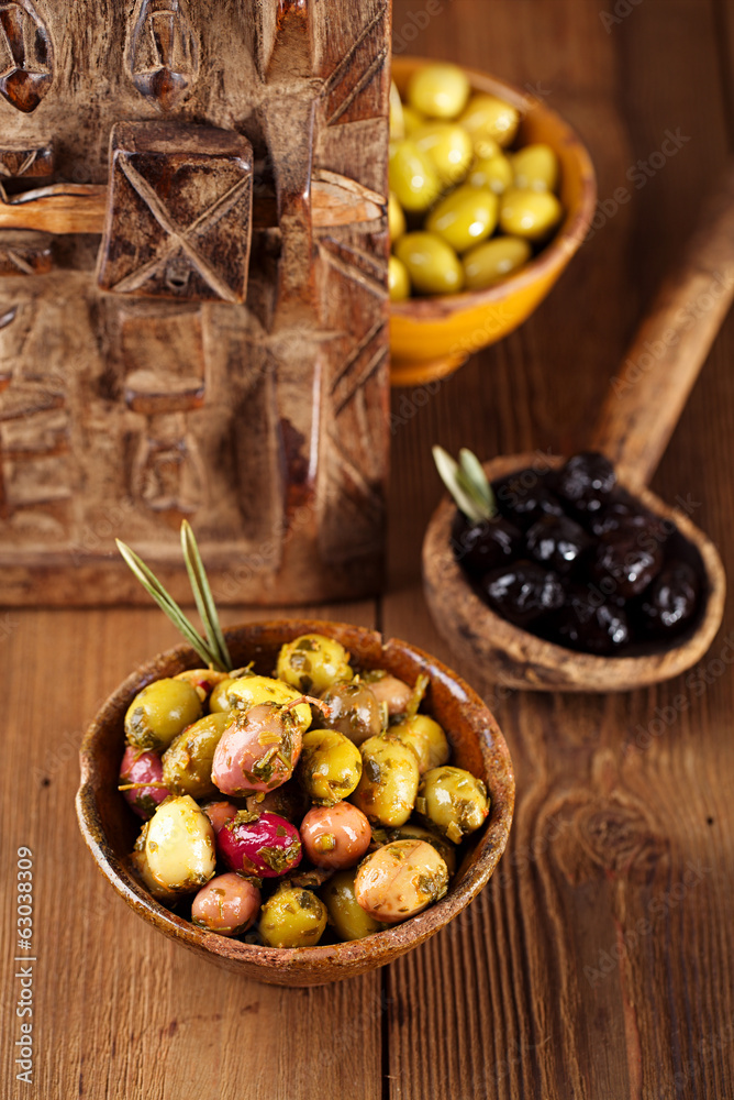 marinated Olives in bowls with moroccan  ornament on wood