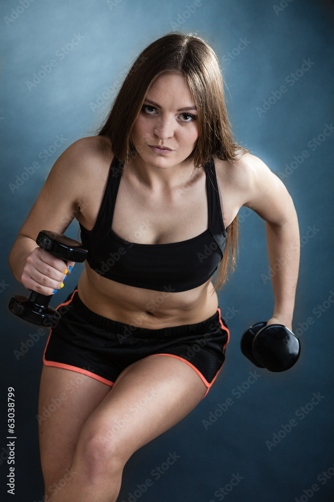 Fitness girl training shoulder muscles lifting dumbbells Fitness girl training shoulder muscles lifting dumbbells