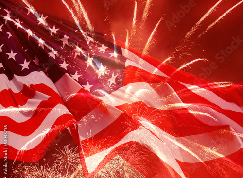 fireworks over waved United States flag