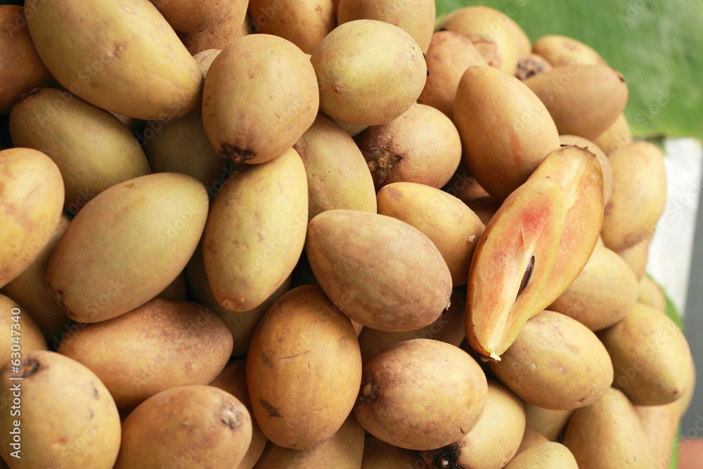 Sapodilla fruit pile in the background Sapodilla fruit pile in the background