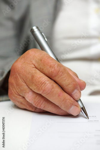 older woman signing the document