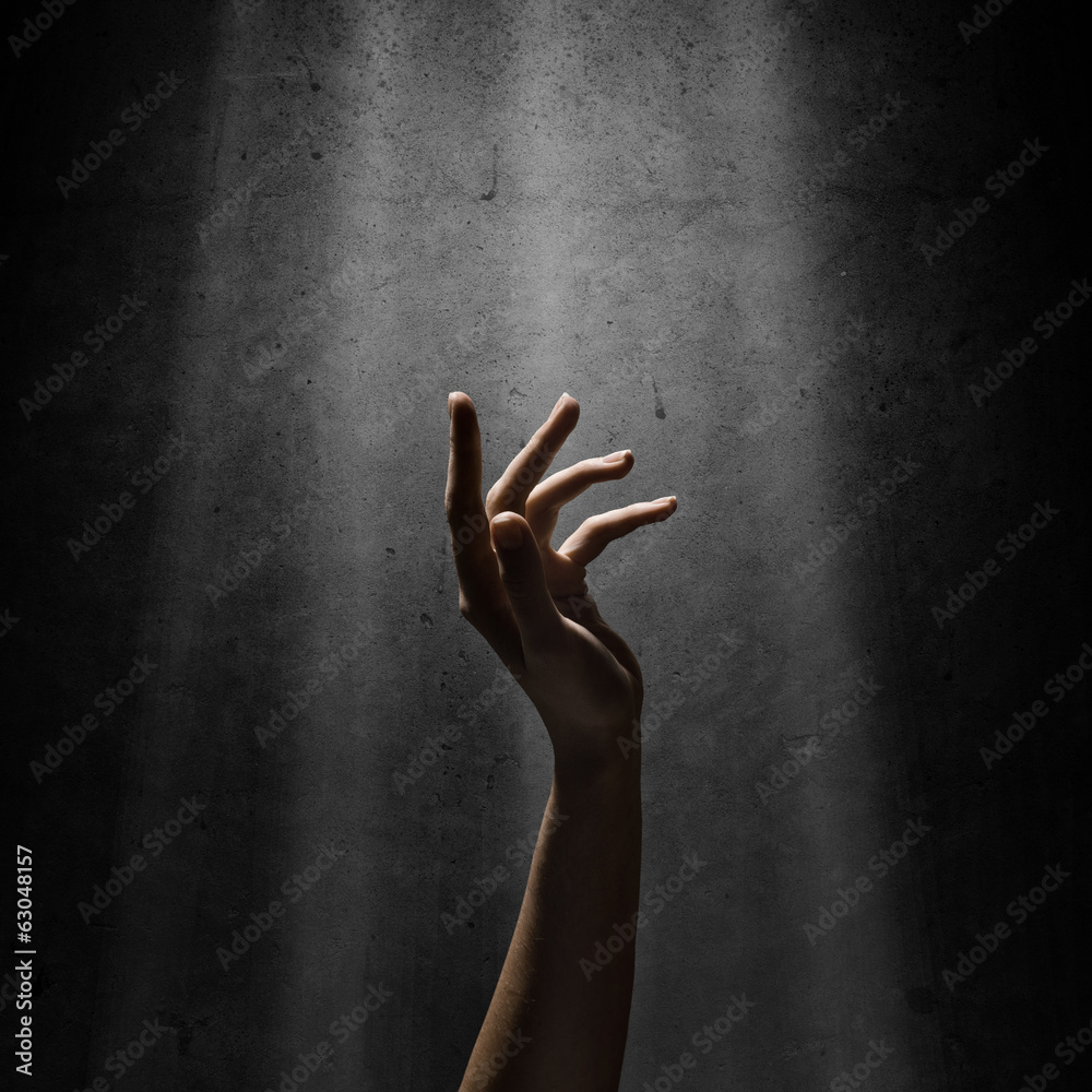 woman's hand reaches for the light rays