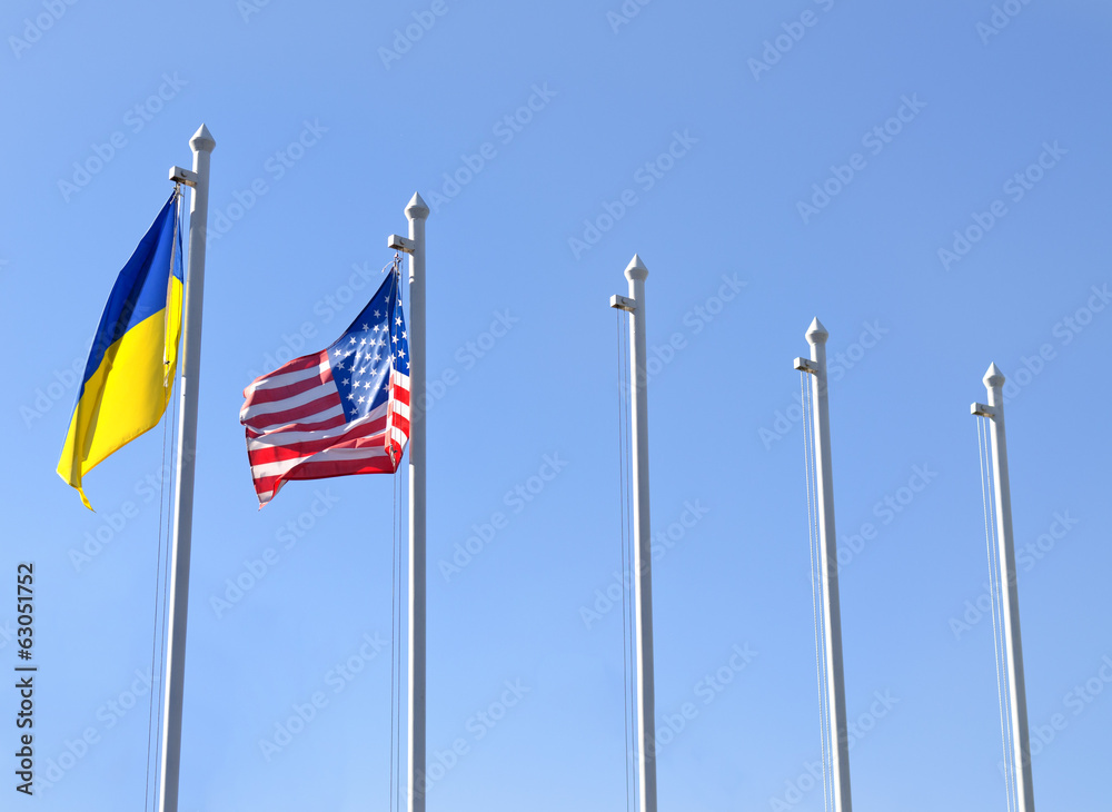 Fag of Ukraine fluttering next to the flag of USA Fag of Ukraine fluttering next to the flag of USA