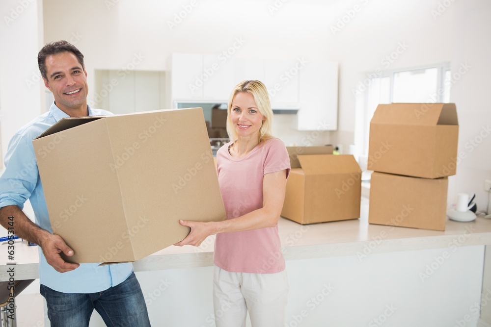 Smiling couple moving together in a new house Smiling couple moving together in a new house
