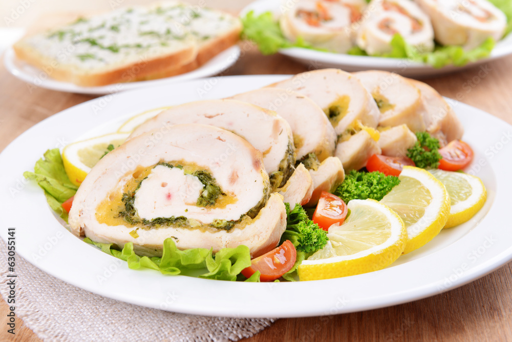 Delicious chicken roll on plate on table close-up