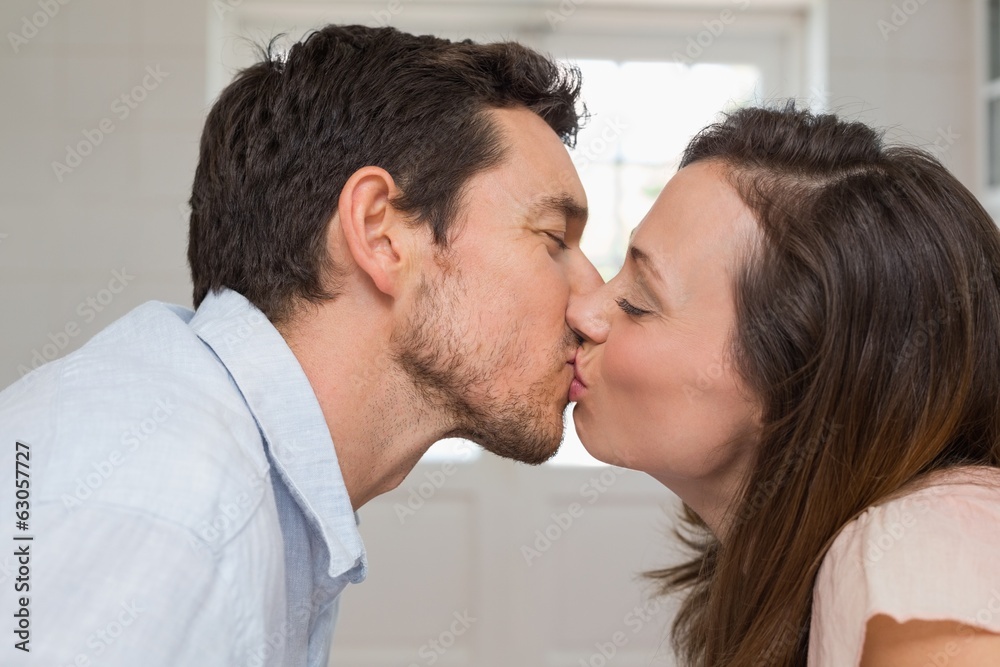 Close-up side view of a loving couple kissing Close-up side view of a loving couple kissing