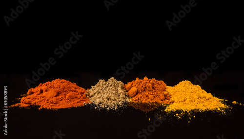 Mix powdered spices on black background