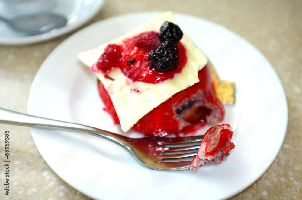 Tasty cake with berries on table in cafe Tasty cake with berries on table in cafe