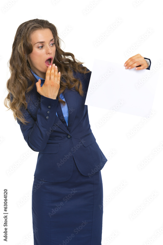 Surprised business woman showing blank paper sheet Surprised business woman showing blank paper sheet