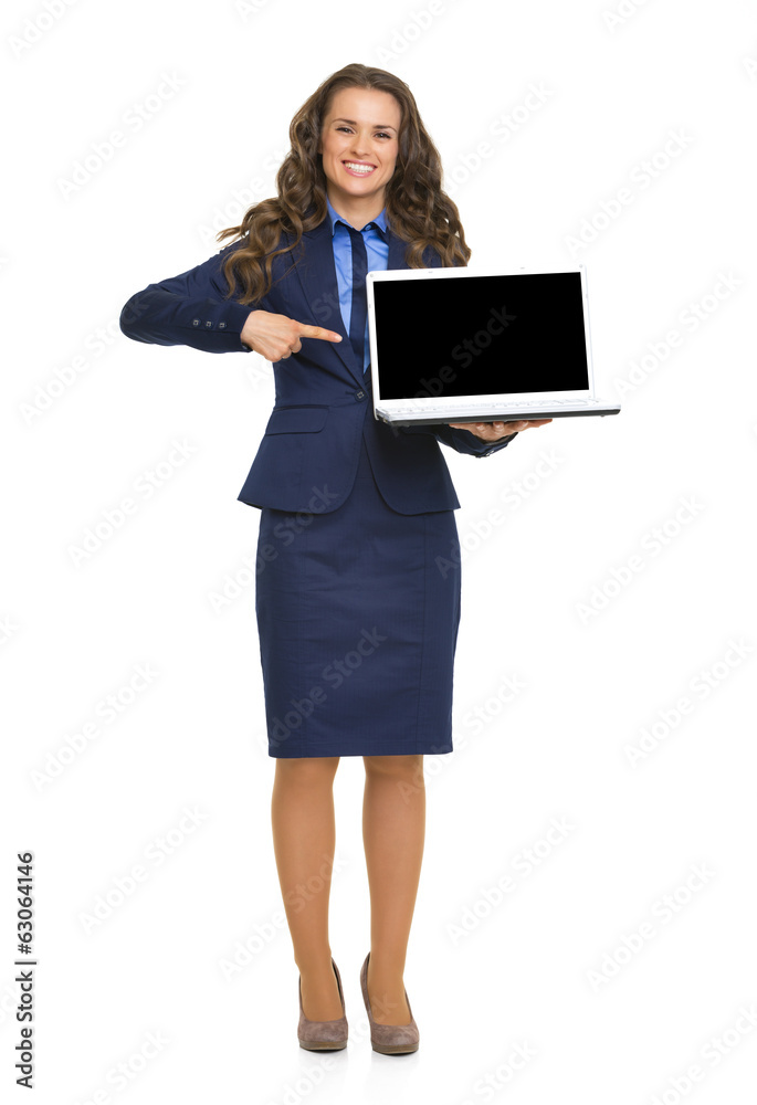 Full length portrait of happy business woman pointing on laptop Full length portrait of happy business woman pointing on laptop