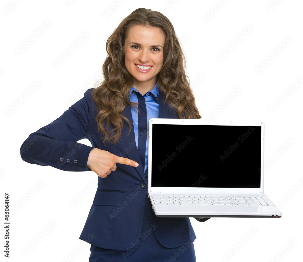 Happy business woman pointing on laptop blank screen Happy business woman pointing on laptop blank screen