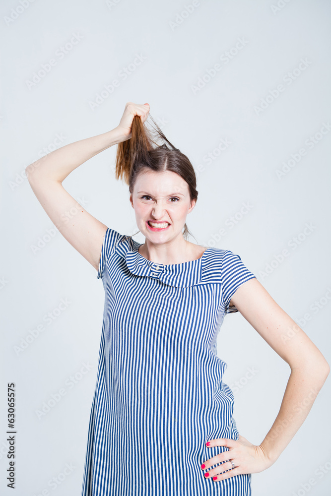 Attractive woman pulling her hair Attractive woman pulling her hair