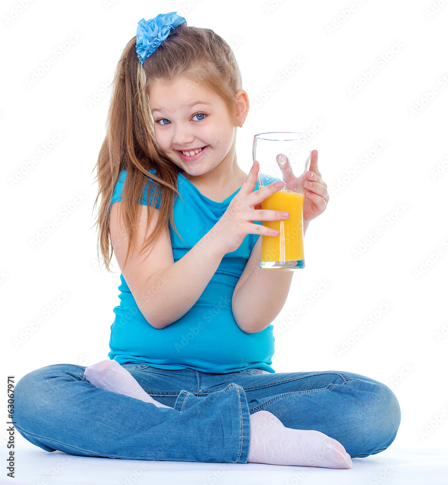 Young girl with glass of orange juice.