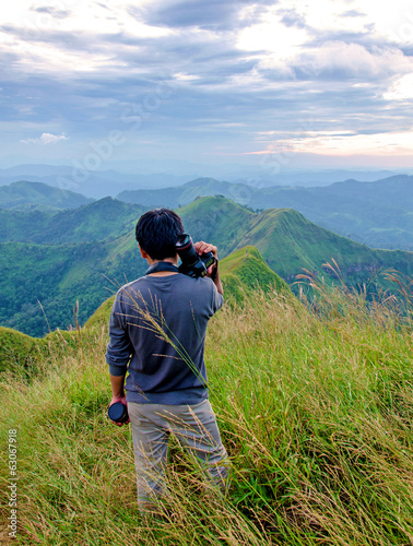Men survey at the top of  (Khao Chang Puak) mountains in Thailan