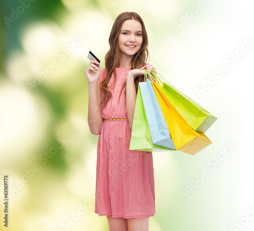 smiling woman in dress with many shopping bags