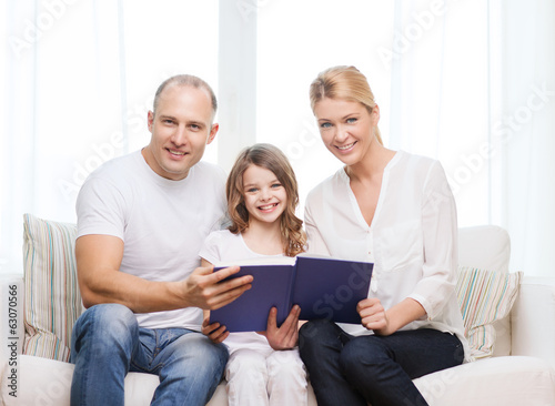 smiling parents and little girl with at home