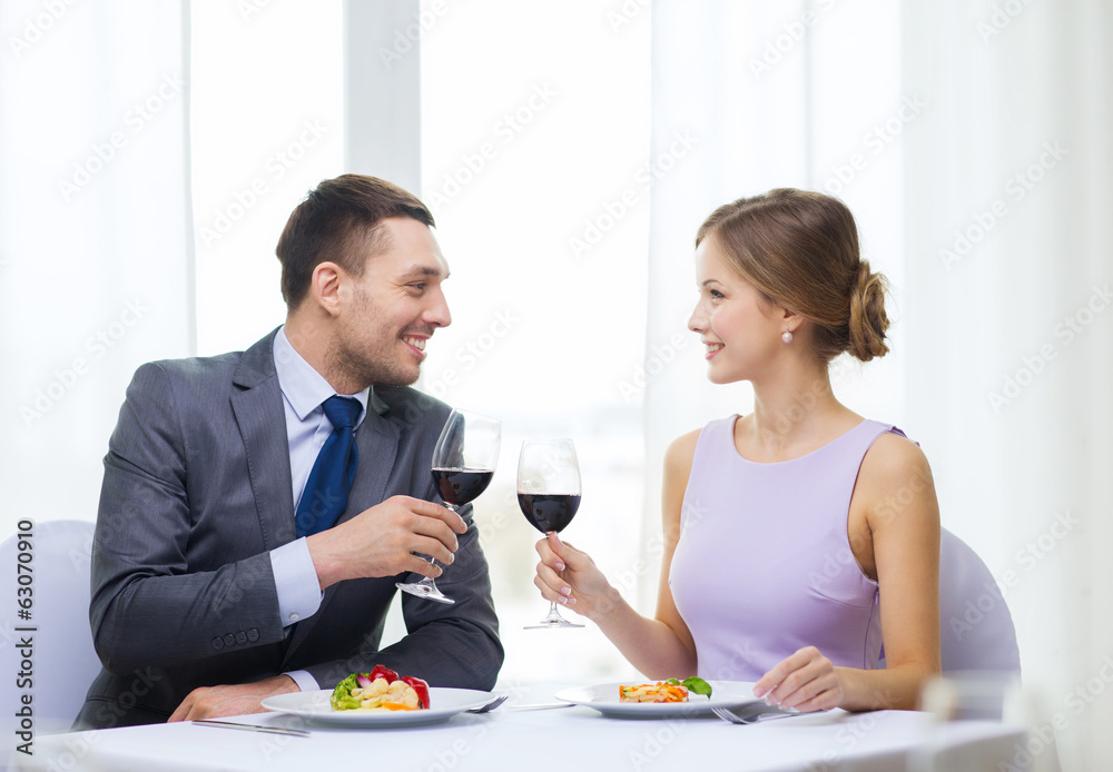 couple with main course and red wine at restaurant couple with main course and red wine at restaurant
