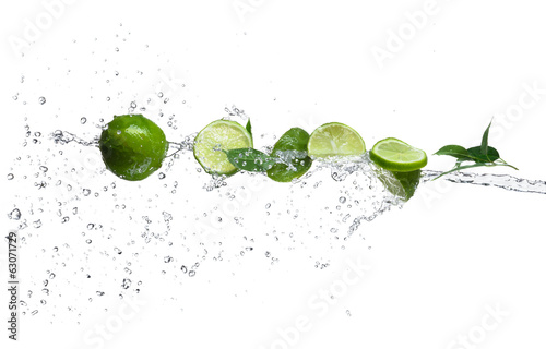 Pieces of limes in water splash #63071729