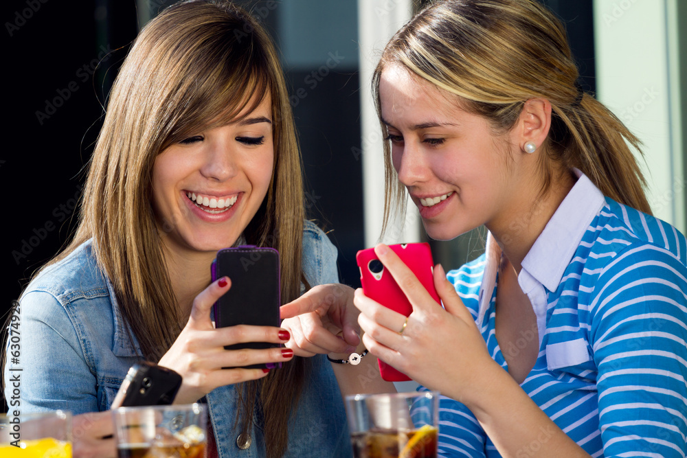 Friends having fun with smartphones Friends having fun with smartphones