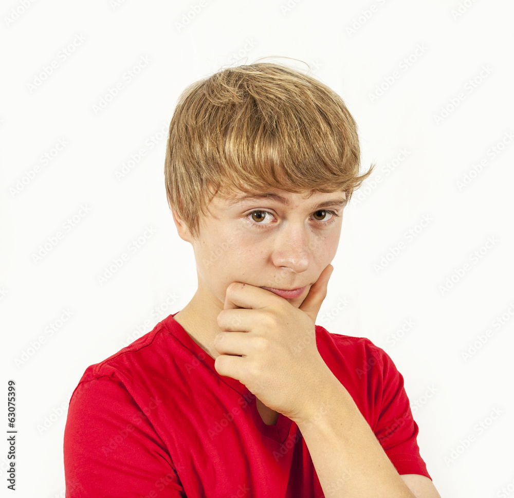 handsome boy in red shirt keeps hand at chin handsome boy in red shirt keeps hand at chin