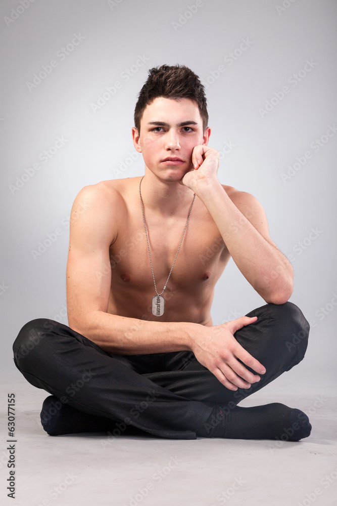 Healthy muscular young man on grey background Healthy muscular young man on grey background