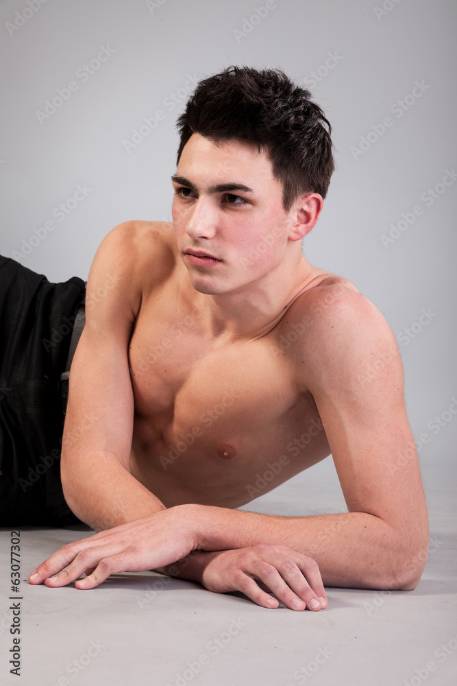 Healthy muscular young man on grey background Healthy muscular young man on grey background