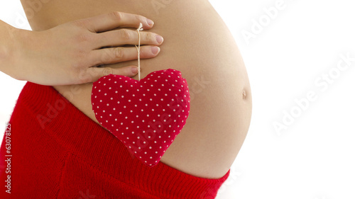 Wallpaper Mural Pregnant belly.Woman expecting a baby holding a heart with love  Torontodigital.ca