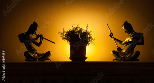 Statues of musicians in backlight photo