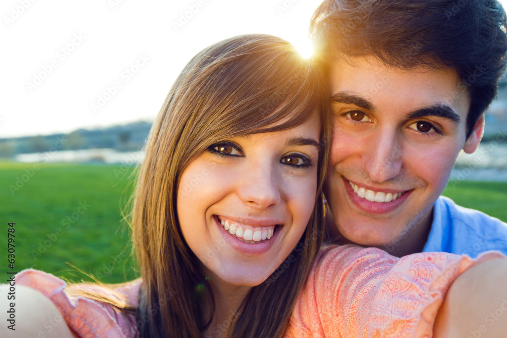 Selfie couple taking photos with a smartphone Selfie couple taking photos with a smartphone