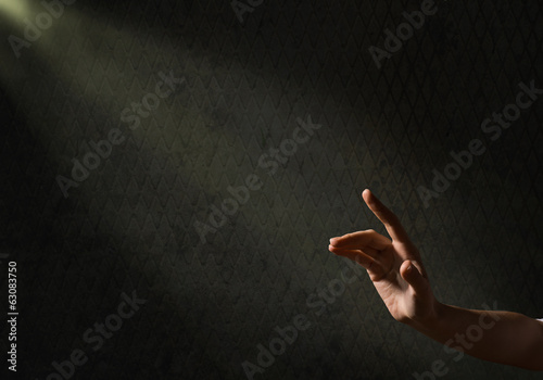 woman's hand reaches for the light rays