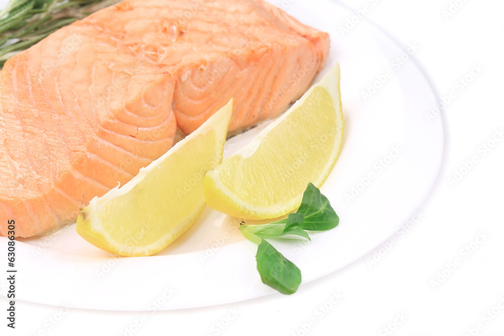 Fried salmon fillet on plate with lemon. Fried salmon fillet on plate with lemon.
