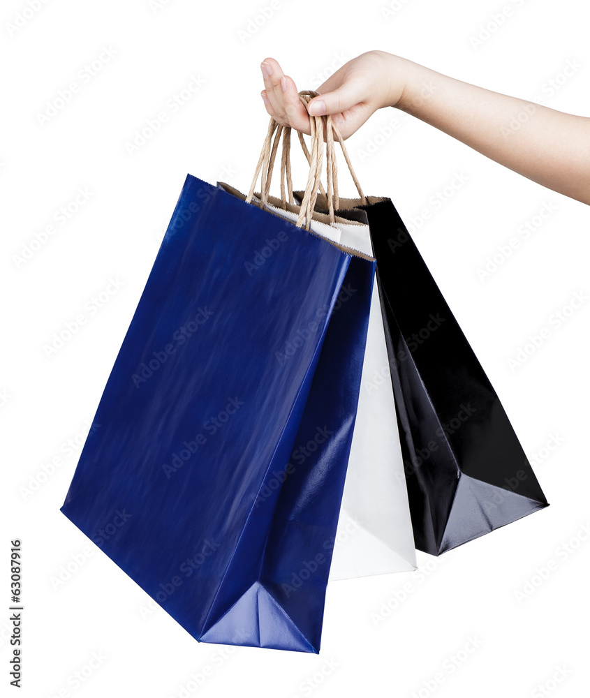 Woman's hand holding paper shopping bags isolated