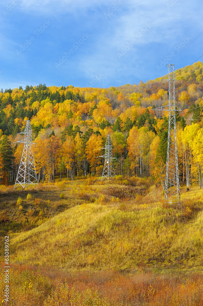 Naklejka premium Power line supports in the Ural mountains in autumn
