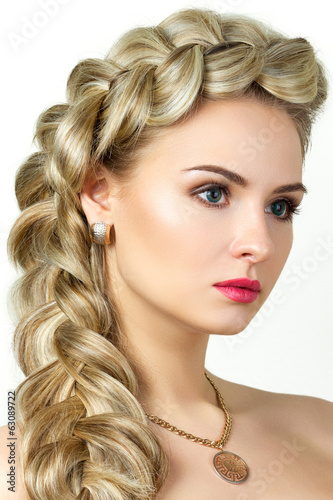 Portrait of young blonde woman with fishtail hair-dress