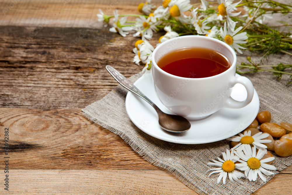 herbal tea with chamomile on old wooden table herbal tea with chamomile on old wooden table