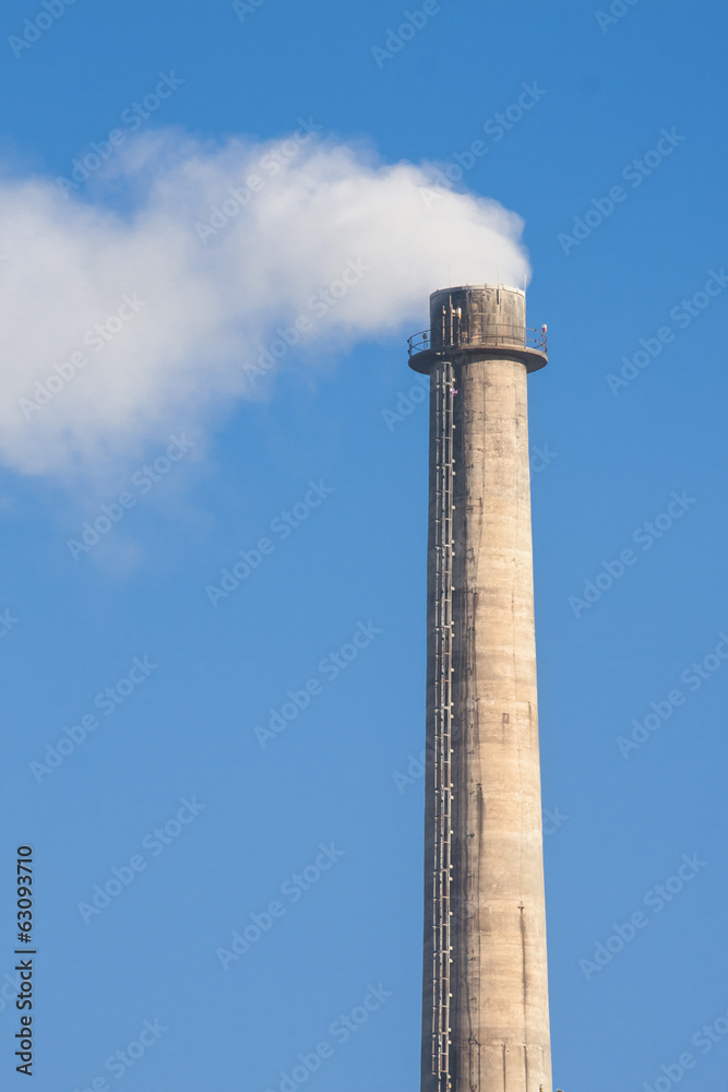 Industrial smoke chimney on blue sky