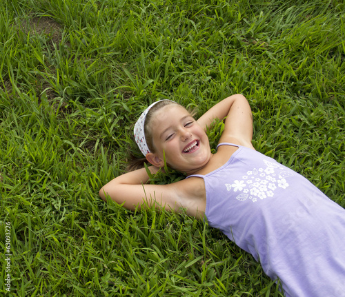Girl lying in grass