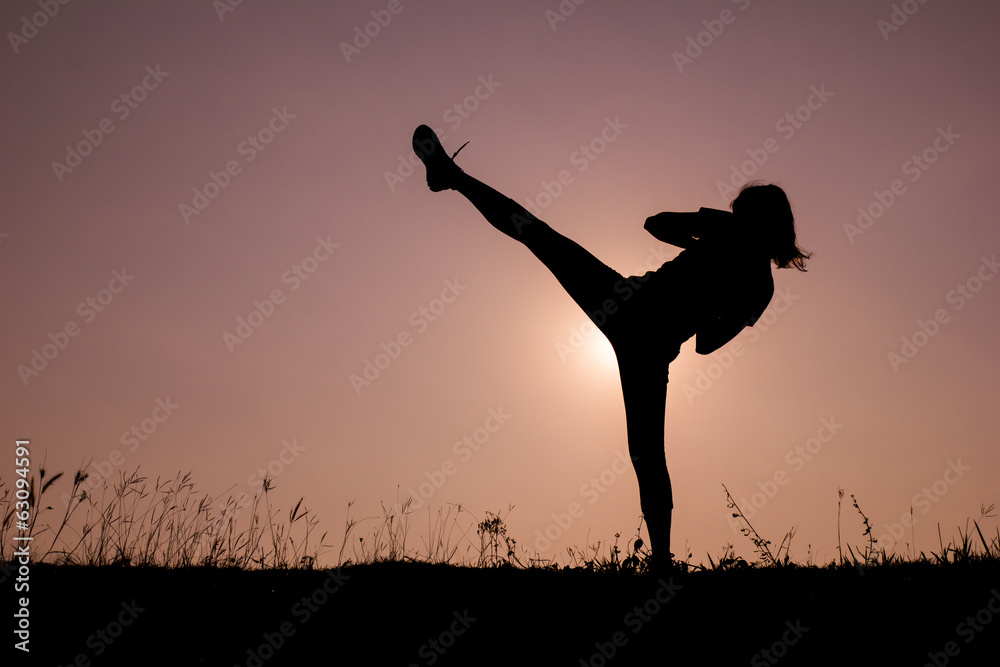 Silhouette of kick boxing girl exercising kick. Silhouette of kick boxing girl exercising kick.