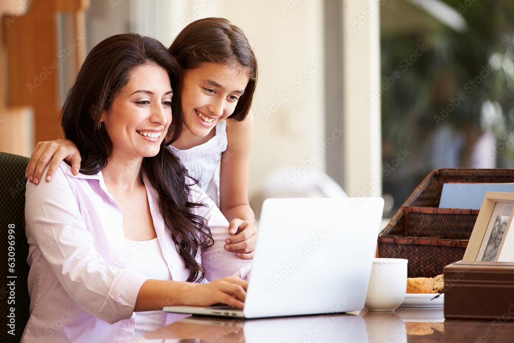 Mother And Teenage Daughter Looking At Laptop Together Mother And Teenage Daughter Looking At Laptop Together