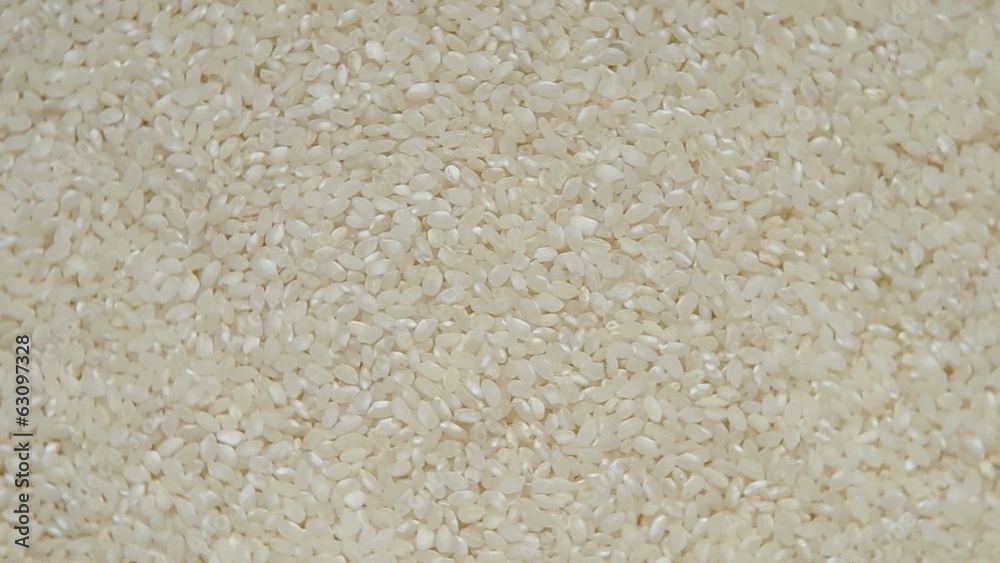 White rice are rotated on the table. White rice are rotated on the table.