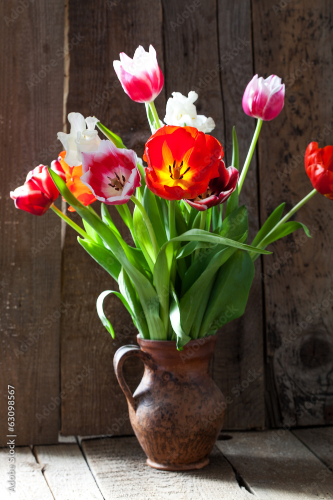 Tulip flowers in wooden background