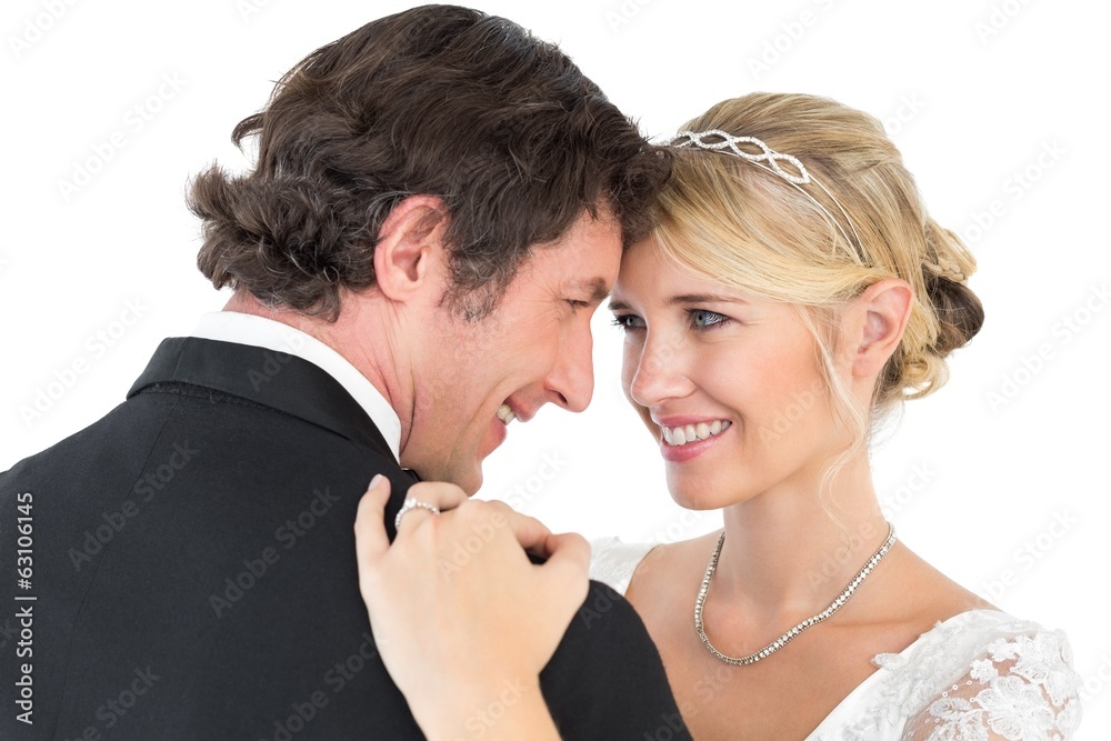 Bride and groom embracing over white background Bride and groom embracing over white background